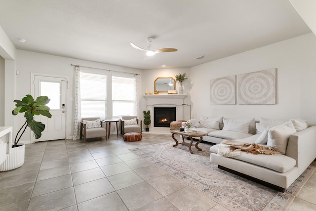 616 Dunster Ln, Saginaw, TX 76131 - tiled living room featuring ceiling fan and a warm lit fireplace