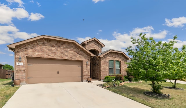 616 Dunster Ln, Saginaw, TX 76131 - view of front of property with brick siding, driveway, a garage, and a front yard