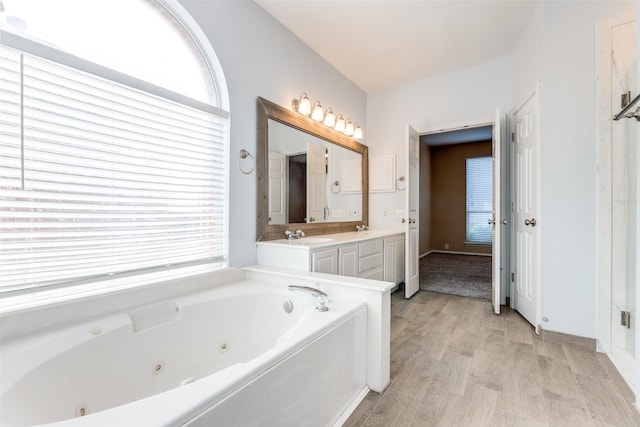 2104 Aberdeen Ave, Mckinney, TX 75072 - full bathroom with a tub with jets, double vanity, and wood finished floors