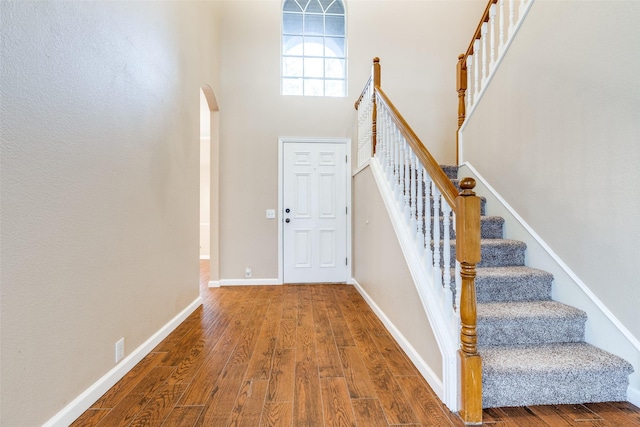2104 Aberdeen Ave, Mckinney, TX 75072 - foyer with wood finished floors, arched walkways, stairs, and a towering ceiling