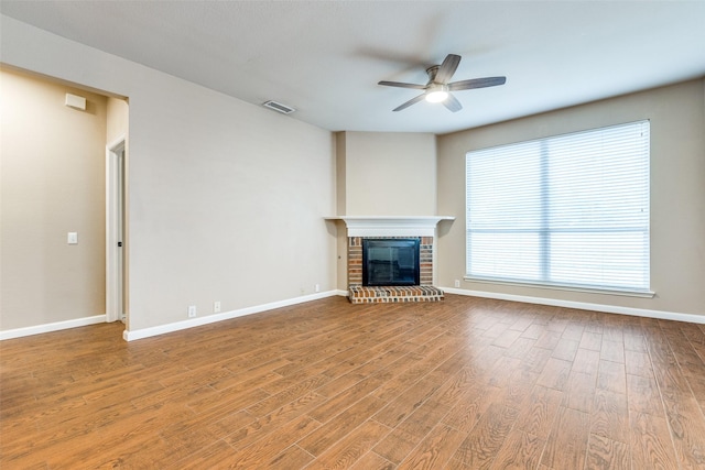 2104 Aberdeen Ave, Mckinney, TX 75072 - unfurnished living room featuring ceiling fan, wood finished floors, and a brick fireplace