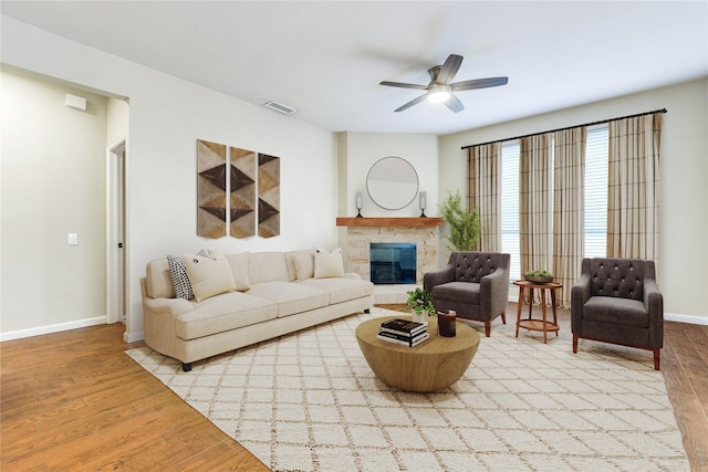 2104 Aberdeen Ave, Mckinney, TX 75072 - living room featuring wood finished floors, ceiling fan, and a glass covered fireplace