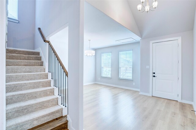 1208 Arcadia Ln, Northlake, TX 76226 - entryway featuring a chandelier, light wood-style floors, stairway, vaulted ceiling, and baseboards