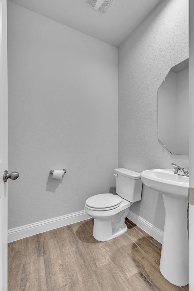 5420 Otter Trl, Fort Worth, TX 76179 - bathroom featuring toilet, wood finished floors, baseboards, and a sink