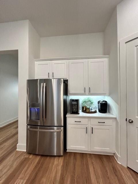 kitchen featuring light countertops, white cabinetry, stainless steel fridge, dark wood-style floors, and baseboards