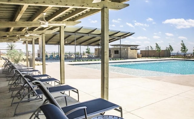 community pool featuring a patio area and fence