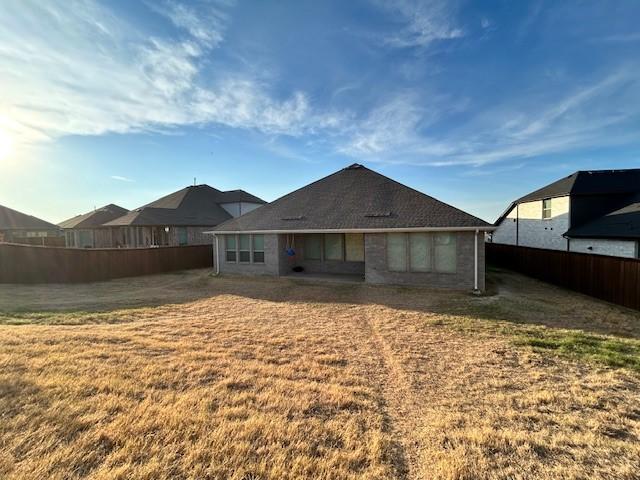 rear view of property with a yard