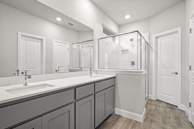 825 Blackhorse Trl, Fort Worth, TX 76247 - bathroom with a shower stall, double vanity, wood finished floors, recessed lighting, and baseboards