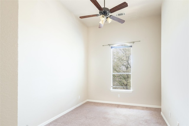 empty room with a ceiling fan, light carpet, baseboards, and visible vents