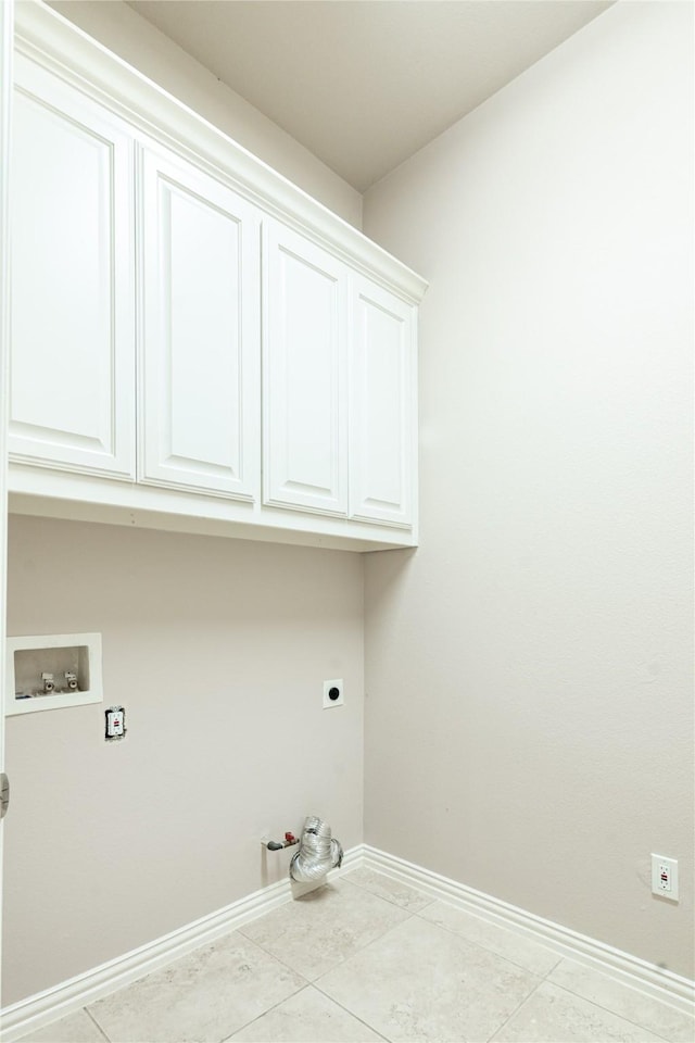 clothes washing area featuring washer hookup, hookup for an electric dryer, baseboards, cabinet space, and gas dryer hookup