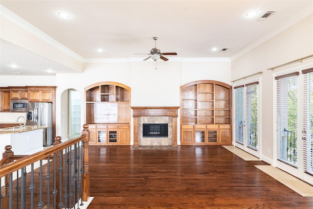 living area with dark wood-style flooring, ornamental molding, and visible vents