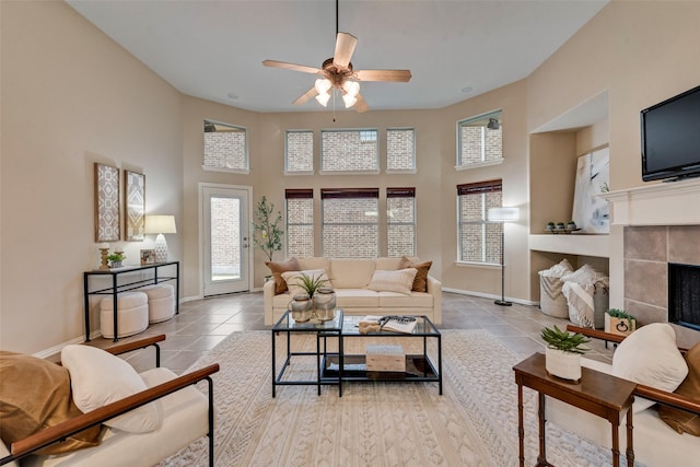 5685 Country View Ln, Frisco, TX 75036 - living area featuring ceiling fan, baseboards, a high ceiling, tile patterned floors, and a fireplace