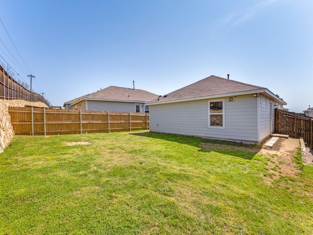 view of yard with a fenced backyard