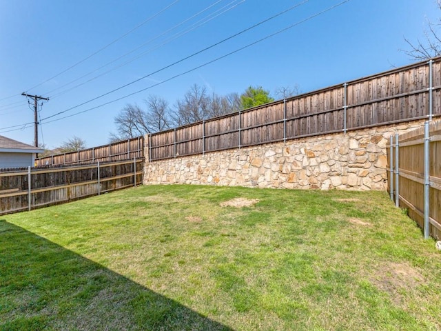 view of yard with a fenced backyard