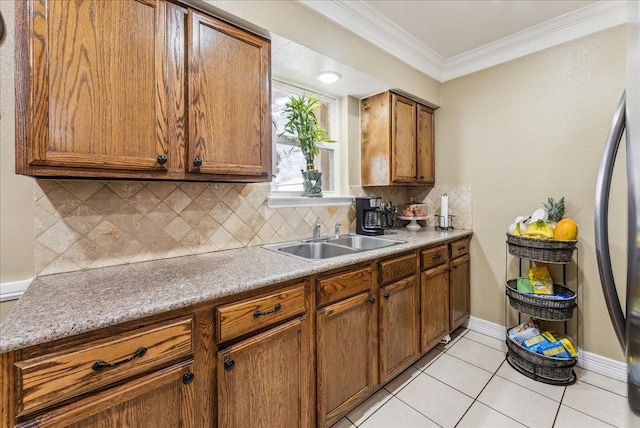 405 Rosewood Hills Dr, Garland, TX 75040 - kitchen with a sink, brown cabinetry, light tile patterned floors, decorative backsplash, and ornamental molding