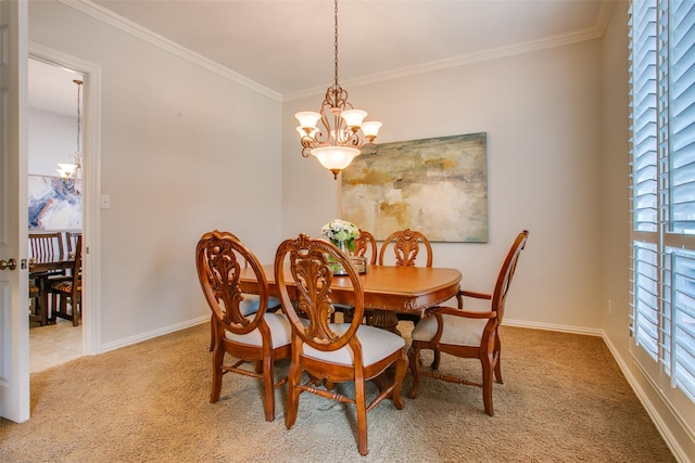 carpeted dining room featuring crown molding, baseboards, and an inviting chandelier