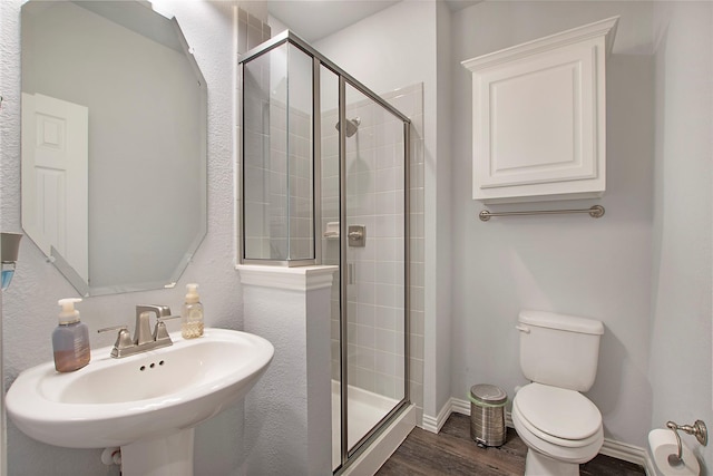 1121 Red Hawk Ln, Forney, TX 75126 - full bathroom featuring toilet, a stall shower, a sink, and wood finished floors