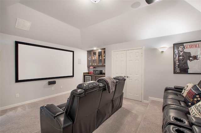 1121 Red Hawk Ln, Forney, TX 75126 - home theater room featuring light colored carpet, bar, baseboards, and vaulted ceiling