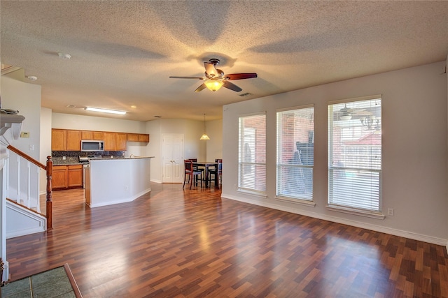 3331 Midstream Ct, Mesquite, TX 75181 - living room with dark wood-type flooring, a textured ceiling, a ceiling fan, baseboards, and stairway