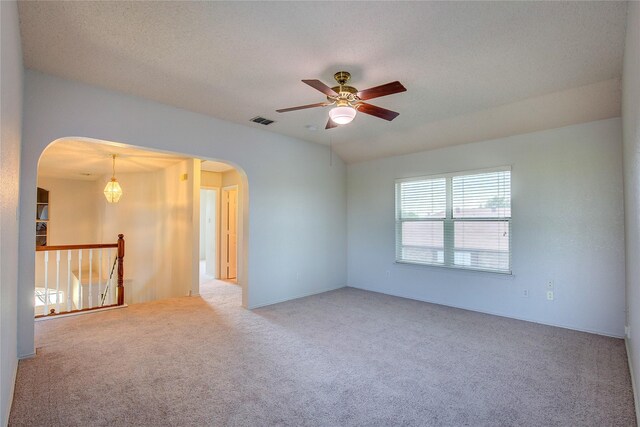 3331 Midstream Ct, Mesquite, TX 75181 - spare room with arched walkways, carpet, ceiling fan, and lofted ceiling