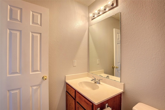 3331 Midstream Ct, Mesquite, TX 75181 - bathroom featuring vanity, a textured wall, and toilet