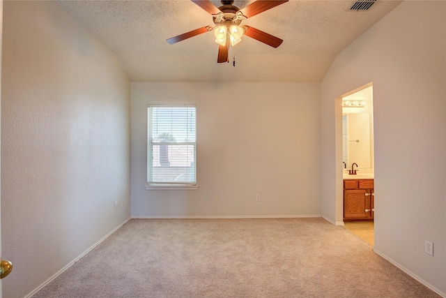 3331 Midstream Ct, Mesquite, TX 75181 - empty room featuring light carpet, a textured ceiling, a ceiling fan, vaulted ceiling, and a sink