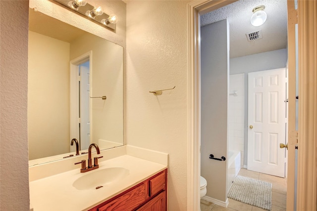 3331 Midstream Ct, Mesquite, TX 75181 - bathroom featuring vanity, tile patterned flooring, toilet, and a textured wall