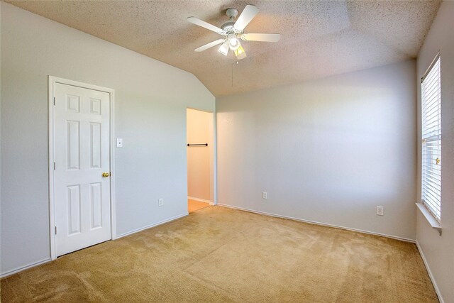 3331 Midstream Ct, Mesquite, TX 75181 - unfurnished bedroom featuring carpet floors, a textured ceiling, lofted ceiling, ceiling fan, and baseboards