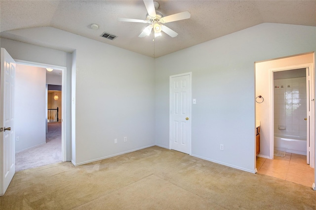 3331 Midstream Ct, Mesquite, TX 75181 - unfurnished bedroom with vaulted ceiling, light carpet, baseboards, ensuite bathroom, and ceiling fan