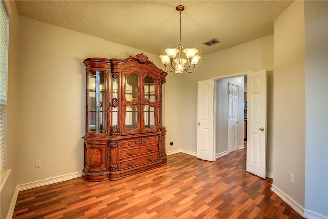 3331 Midstream Ct, Mesquite, TX 75181 - spare room with dark wood-style floors, a chandelier, and baseboards