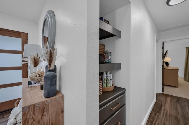 hallway with baseboards and wood finished floors