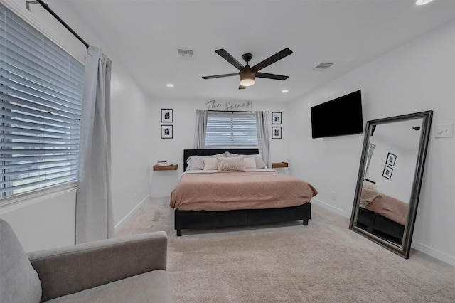 bedroom featuring multiple windows, visible vents, baseboards, and carpet