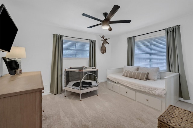 bedroom with baseboards, a ceiling fan, and light carpet