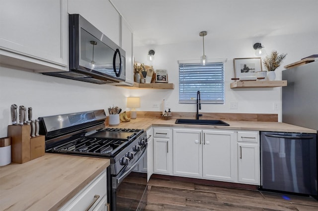 kitchen featuring white cabinets, a sink, stainless steel appliances, and open shelves