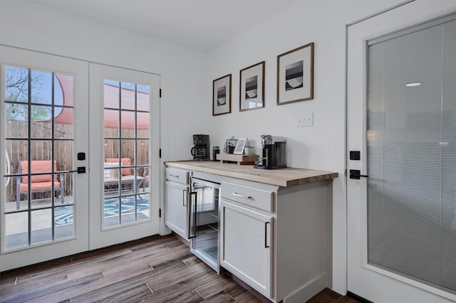 doorway featuring french doors, dark wood-style flooring, a dry bar, and wine cooler