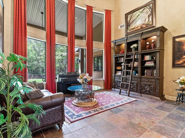 9 Eagle Pt N Unit A, Azle, TX 76020 - living area with stone tile floors, baseboards, and a towering ceiling