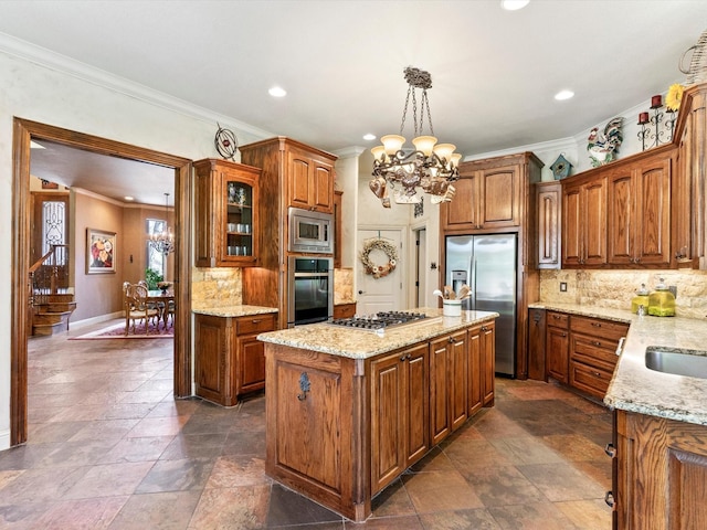 9 Eagle Pt N Unit A, Azle, TX 76020 - kitchen with appliances with stainless steel finishes, a chandelier, a kitchen island, crown molding, and backsplash
