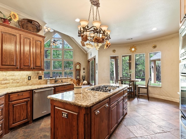 9 Eagle Pt N Unit A, Azle, TX 76020 - kitchen with appliances with stainless steel finishes, a kitchen island, stone tile flooring, a sink, and a chandelier