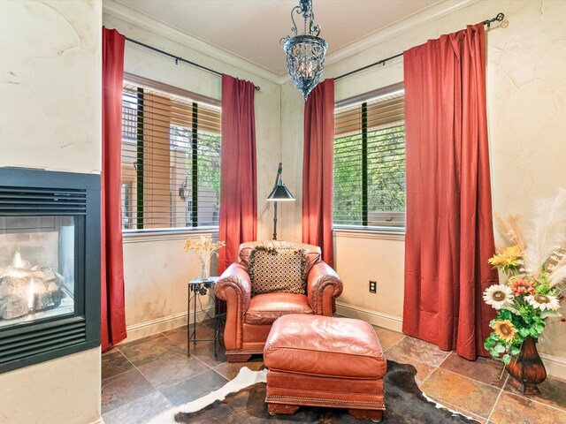 9 Eagle Pt N Unit A, Azle, TX 76020 - sitting room with ornamental molding, plenty of natural light, stone tile flooring, baseboards, and a multi sided fireplace