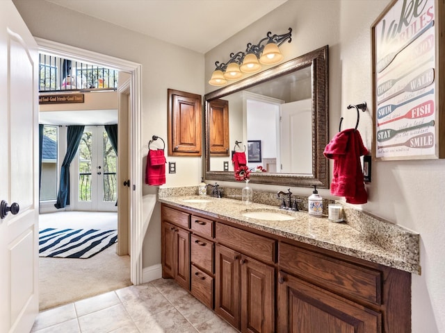 9 Eagle Pt N Unit A, Azle, TX 76020 - bathroom featuring french doors, double vanity, tile patterned floors, and baseboards