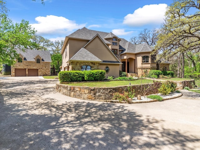 9 Eagle Pt N Unit A, Azle, TX 76020 - view of front of home featuring stone siding, stucco siding, driveway, and a garage