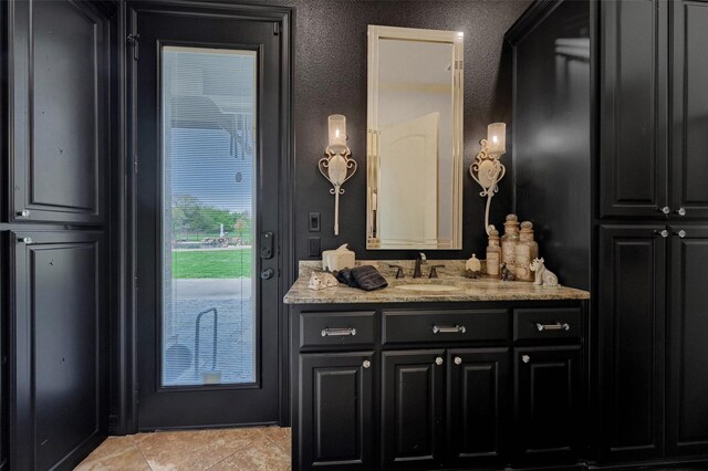 7545 Colton Ln, Pilot Point, TX 76258 - bathroom with vanity, tile patterned flooring, and a textured wall