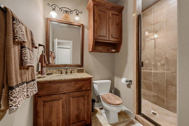 7545 Colton Ln, Pilot Point, TX 76258 - full bath with toilet, vanity, a stall shower, and tile patterned flooring
