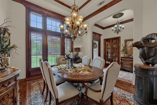 7545 Colton Ln, Pilot Point, TX 76258 - dining space with a chandelier, arched walkways, wood finished floors, crown molding, and baseboards