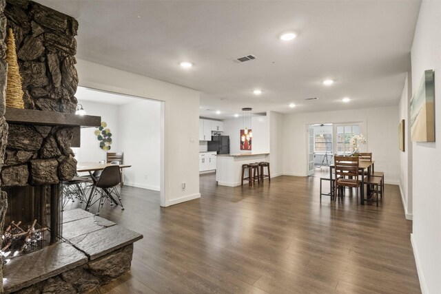 1018 Brookhollow Dr, Irving, TX 75061 - living room with a stone fireplace, dark wood finished floors, recessed lighting, and baseboards