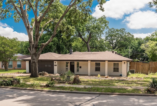 1018 Brookhollow Dr, Irving, TX 75061 - ranch-style home featuring a garage, fence, brick siding, and covered porch
