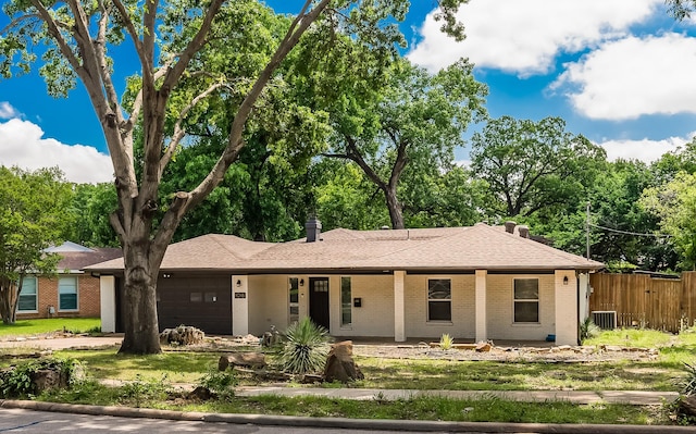 1018 Brookhollow Dr, Irving, TX 75061 - ranch-style home featuring an attached garage, brick siding, covered porch, fence, and roof with shingles