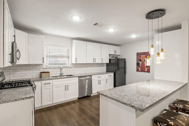 1018 Brookhollow Dr, Irving, TX 75061 - kitchen featuring stainless steel appliances, a sink, a peninsula, backsplash, and light stone countertops