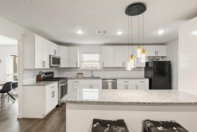 1018 Brookhollow Dr, Irving, TX 75061 - kitchen featuring appliances with stainless steel finishes, a sink, dark wood-type flooring, backsplash, and recessed lighting