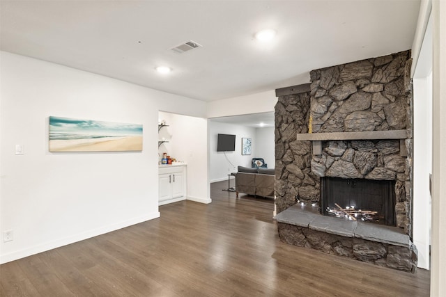 1018 Brookhollow Dr, Irving, TX 75061 - living area with wood finished floors, baseboards, and a stone fireplace